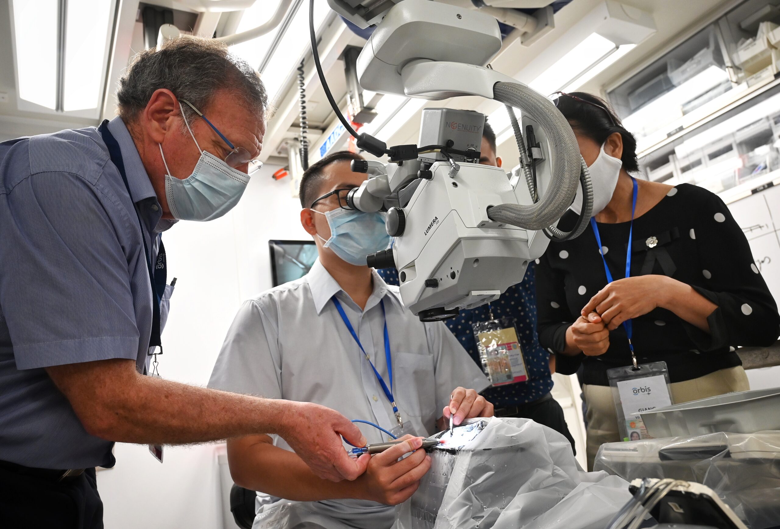 Ophthalmologist Larry Benjamin trains local eye surgeons in Vietnam for charity Orbis