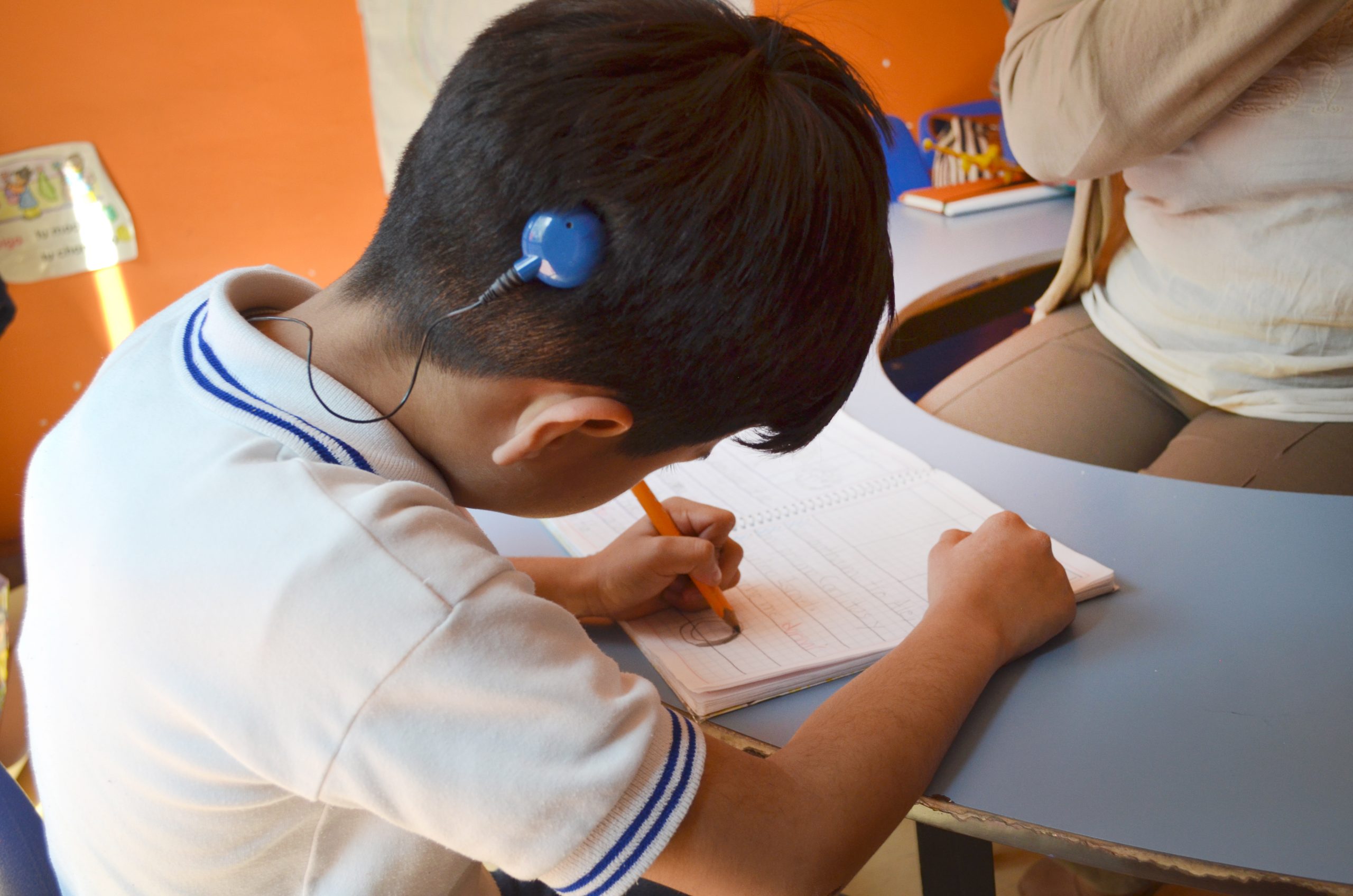 Deafblind boy wearing cochlear implant